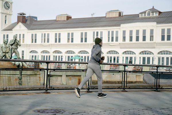 Active man jogging outside during sunset
