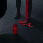 Sports shoes and water bottle on gym floor